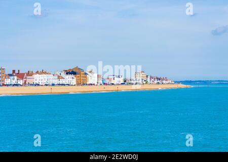 Traditional fishing boat and seagulls relaxing on a pebble beach, looking north to the pier,Deal, Kent ,Great Britain,July 2016 Stock Photo