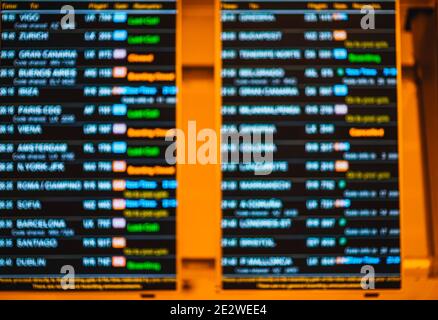 Screens displaying flight information for passengers in airport terminal Stock Photo