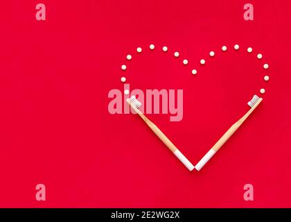 Bamboo toothbrushes and eco toothpaste in tablets. Creative heart. Stock Photo