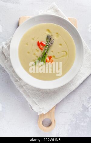 Cream of asparagus with pepper on cutting board Stock Photo