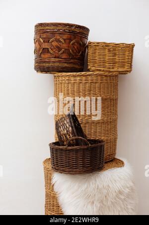 Stack of six different wicker baskets, handmade craft home storage Stock Photo