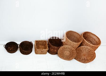 Top view of many empty natural handmade wicker straw baskets in row Stock Photo
