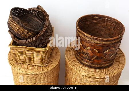 Close up many wicker straw baskets with caps and handles Stock Photo