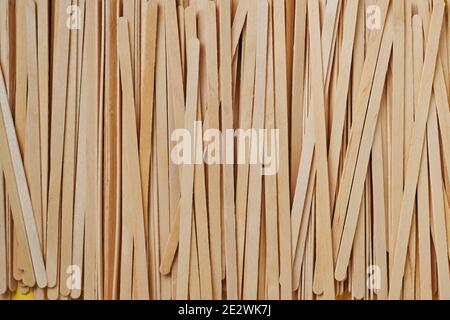 Wooden Drink Stirrers and eco paper glasses background. Zero waste and plastic free concept. Top view. Stock Photo