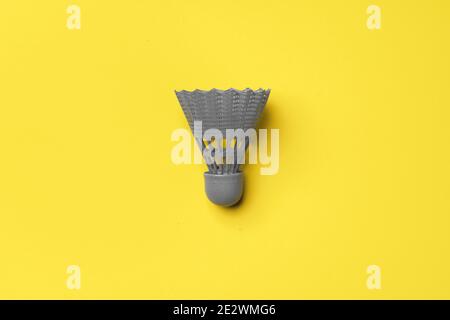 Gray shuttlecock on yellow background top view Stock Photo