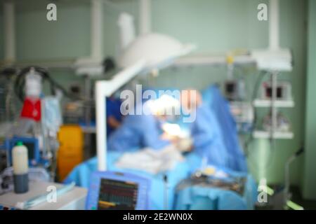 Unfocused background of working surgical staff in hospital. Stock Photo