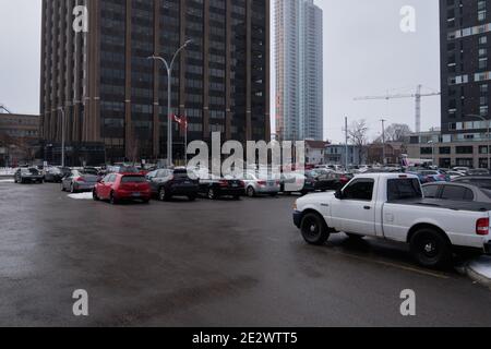 with Ontario entering a "state of emergency" due to Covid, the parking Lot of a Government tower in Ottawa is still over half full in Ottawa, Canada Stock Photo