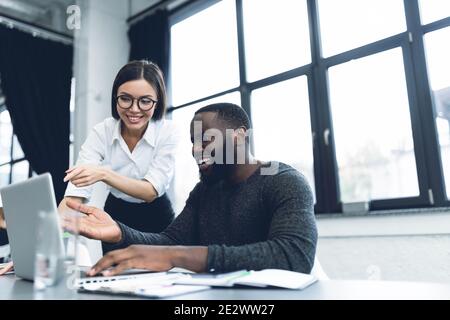 Young and heterogeneous co-workers working with pc in the office Stock Photo