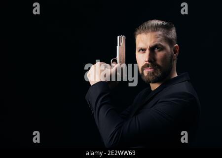 Aggressive bandit posing with weapon in hands Stock Photo