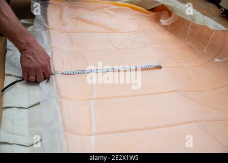 Marking the case on the sofa for sewing. DIY. Repair soft furniture Stock Photo