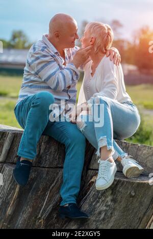 happy senior couple dating, hugging and kissing outdoor at sunset Stock Photo