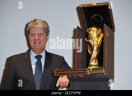 LVMH Communication Director, Antoine Arnault poses next to the travel case  made by Louis Vuitton to carry the FIFA World Cup Trophy containing a  replica during a press presentation held at the