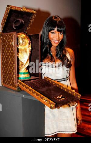 Director of the special requests department of French luxury bag  manufacturer Louis Vuitton, Patrick-Louis Vuitton poses next to the travel  case made by Louis Vuitton to carry the FIFA World Cup Trophy