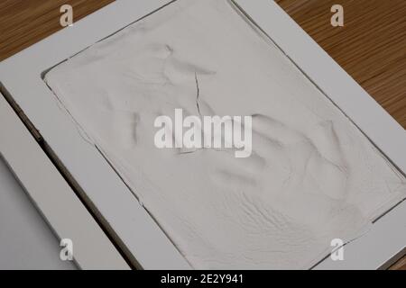 Child's handprints in plaster cast. Home. Stock Photo