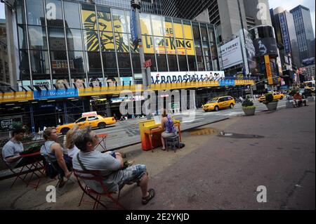 A women plays a piano in Times Square of New York, Monday, June 23, 2010. The piano, one of 60, is part of an art installation touring the world that makes its first U.S. stop in New York. The concept has put more than 130 pianos in parks, squares and bus stations in cities from London to Sydney, Australia. Photo by Mehdi Taamallah/ABACAPRESS.COM Stock Photo