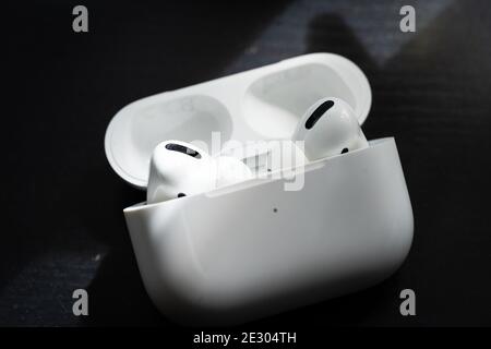 Apple Airpods Pro isolated on wooden surface. The new airpods pro features active noise cancelling and customizable fit Stock Photo