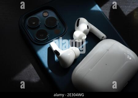 Apple Airpods Pro isolated on wooden surface. The new airpods pro features active noise cancelling and customizable fit Stock Photo