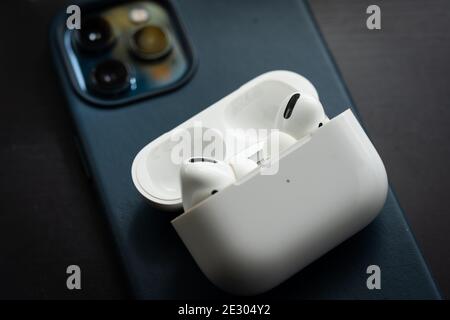 Apple Airpods Pro isolated on wooden surface. The new airpods pro features active noise cancelling and customizable fit Stock Photo