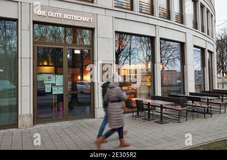 Hamburg, Germany. 15th Jan, 2021. Passers-by walk past the restaurant: 'The Good News'. (Wipe effect by long time exposure) Credit: Georg Wendt/dpa/Alamy Live News Stock Photo
