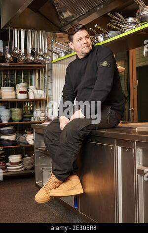 Hamburg, Germany. 15th Jan, 2021. TV chef Tim Mälzer sits in the kitchen of his restaurant 'Die Gute Botschaft'. Credit: Georg Wendt/dpa/Alamy Live News Stock Photo