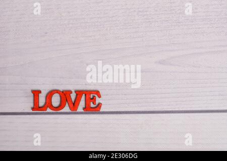 the inscription love on a wooden background. layout.