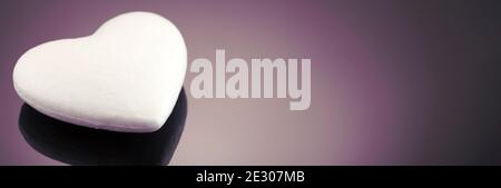 White 3d heart made of polystyrene, on a dark background with place for text. Artificial love concept, frozen heart. Studio photo. Valentine's Day. Si Stock Photo