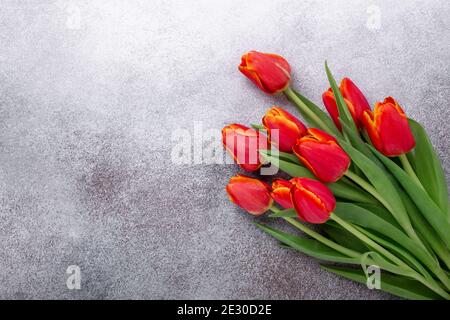 Wonderful spring tulips on a light stone table. Spring background. Top view. Copy space - Image Stock Photo