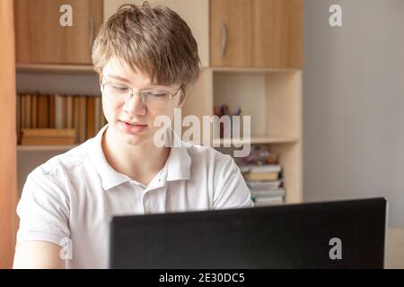 Student learning at home using laptop. Home school, online education, home education, quarantine concept - Image Stock Photo