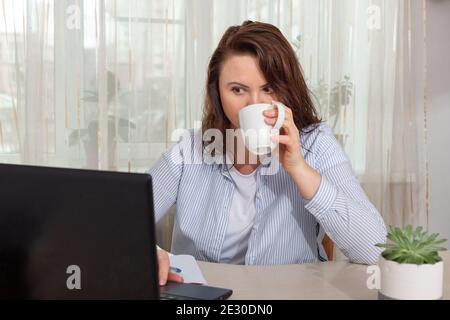 Female programmer or freelancer working from home, remote, home office. Remote work concept - Image Stock Photo
