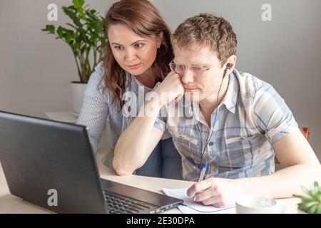 Two programmers, man and woman working from home, remote, home office. Remote work concept - Image Stock Photo