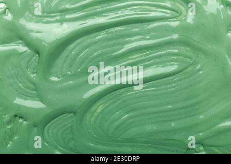 Cosmetic clay mask for face and body. Green texture. Close-up - Image Stock Photo