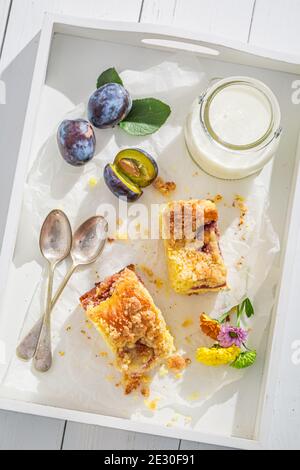 Tasty and homemade plum pie on white board in summer Stock Photo