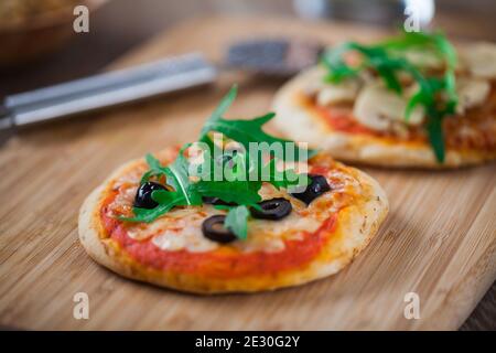 Mini Pizzas served on Wooden Board. High quality photo. Stock Photo