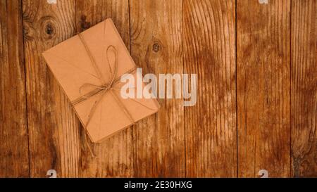 A lot of envelopes from kraft paper tied with string on a wooden background Stock Photo