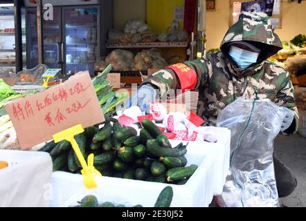 (210116) -- BEIJING, Jan. 16, 2021 (Xinhua) -- A staff member puts vegetables for sale at a neighborhood supermarket in the Xueyuanlu sub-district of Haidian District, Beijing, capital of China, Jan. 16, 2021. With the Chinese Lunar New Year approaching, Beijing's Xueyuanlu sub-district has adopted multiple methods to ensure vegetable supplies to its residents. (Xinhua/Ren Chao) Stock Photo