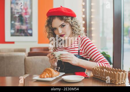 Attractive woman drinking coffee in cafe Stock Photo