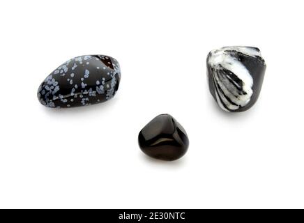 Polished gemstones - three various obsidians on white background Stock Photo