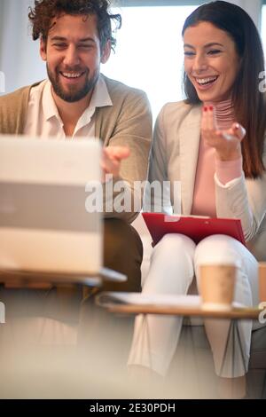 Young cheerful business couple working from home in a pleasant atmosphere. Business, people, work from home Stock Photo