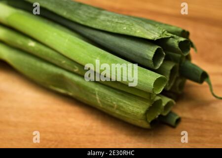 Fresh green spring onions on a cutting board ready for chopping Stock Photo