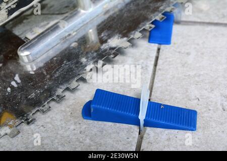 Tile levelling system with plastic clips, wedges and equipment. Stock Photo
