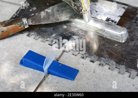 Tile levelling system with plastic clips, wedges and equipment. Stock Photo