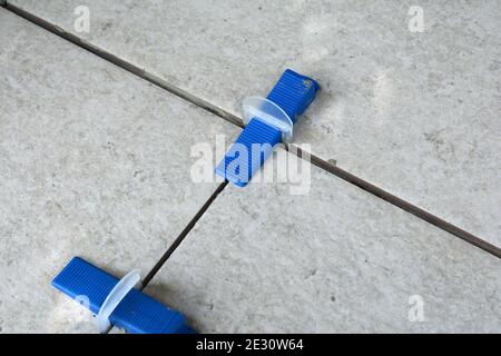 Tile levelling system with plastic clips, wedges and equipment. Stock Photo