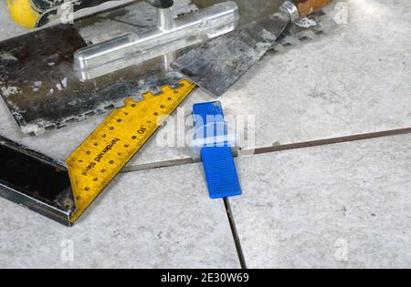 Tile levelling system with plastic clips, wedges and equipment. Stock Photo
