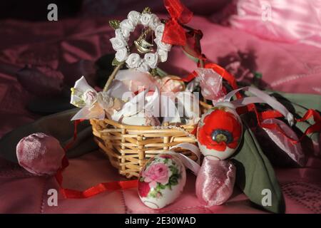 little basket  decorated ribbons and bows with candy eggs for Easter gifts Stock Photo