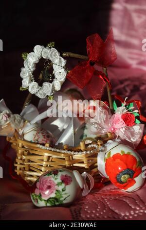 little basket  decorated ribbons and bows with candy eggs for Easter gifts Stock Photo
