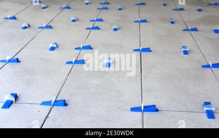 Tile leveling system with plastic clips and wedges, shot while the tile mortar sets Stock Photo
