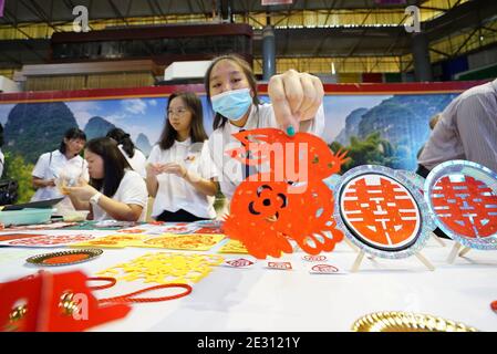 (210116) -- BEIJING, Jan. 16, 2021 (Xinhua) -- Local people display Chinese paper cutting during the opening ceremony of the China Day Cultural Carnival in Bandar Seri Begawan, capital of Brunei, Dec. 26, 2020. TO GO WITH XINHUA HEADLINES OF JAN. 16, 2021 (Photo by Jeffrey Wong/Xinhua) Stock Photo