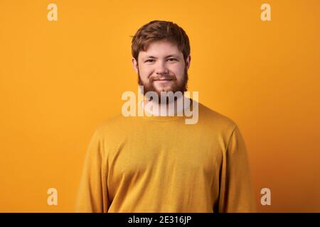 Troubled displeased bearded man frowns face, feels sad, distressed and upset, being bored sitting on quarantine, unhappy to miss good chance, dressed Stock Photo