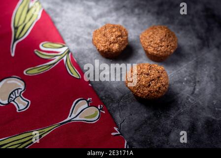 Side Lighting creating contrast on homemade cupcakes with red napkin Stock Photo