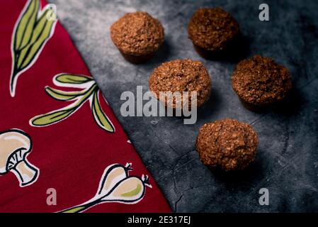 Back Lighting of homemade cupcakes on granite with red napkin Stock Photo
